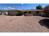 Charming single story home with desert landscaping, neutral color palette, and brick walkway leading to entrance at 2022 Leisure World --, Mesa, AZ 85206