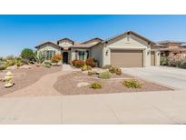 Attractive single-story home with desert landscaping, paved walkway, and a two-car garage at 20506 N 271St Ave, Buckeye, AZ 85396