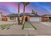 Charming single-story home featuring palm trees, a modern entrance, and a well-manicured front yard at 2905 W Campo Bello Dr, Phoenix, AZ 85053