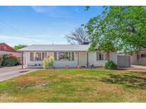 Charming single-story home featuring a well-maintained lawn and a freshly painted exterior at 3243 E Sheridan St, Phoenix, AZ 85008