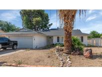 Charming single-story home with low-maintenance landscaping and a two-car garage, set against a bright sky at 4813 W Belmont Ave, Glendale, AZ 85301
