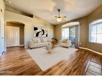 Bright living room boasts neutral furniture, wood floors and sliding glass door for lots of natural light at 5335 E Shea Blvd # 2045, Scottsdale, AZ 85254