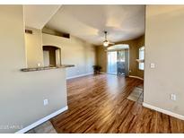 Bright living room with wood floors, ceiling fan, and sliding door access to the outside patio at 5335 E Shea Blvd # 2045, Scottsdale, AZ 85254