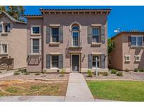 Charming home featuring symmetrical facade with dark shutters and a small balcony above the entry door at 5628 S 21St Pl, Phoenix, AZ 85040