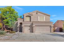 Charming two-story home featuring a three car garage and well-maintained landscaping at 648 W Cobblestone Dr, Casa Grande, AZ 85122