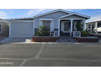 Charming single-story home with a well-maintained yard and inviting front porch at 650 N Hawes Rd # 4123, Mesa, AZ 85207