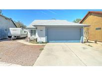Charming single-story home with a gray and white exterior, a two-car garage, and a well-kept yard at 6826 S 16Th Way, Phoenix, AZ 85042