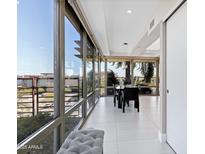 Bright dining room with floor to ceiling windows and a modern dining table set at 7137 E Rancho Vista Dr # 6011, Scottsdale, AZ 85251