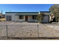Charming single-story home with a fenced front yard, green roof and a one car garage at 7139 E Arcadia Cir, Mesa, AZ 85208