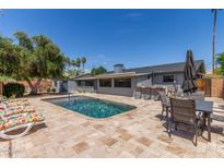 Spacious backyard featuring a refreshing in-ground swimming pool and inviting lounge chairs at 7727 E 4Th St, Scottsdale, AZ 85251