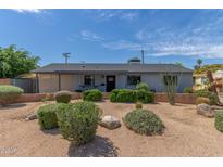 Charming single-story home with desert landscaping, providing a low-maintenance and attractive exterior at 7727 E 4Th St, Scottsdale, AZ 85251