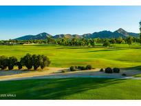 Expansive golf course with lush green fairways surrounded by mature trees and mountain views on a sunny day at 8312 N Golf Dr, Paradise Valley, AZ 85253