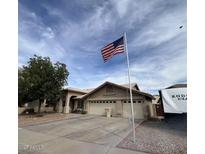 Charming single-story home with a three-car garage and an American flag in a well-maintained community at 8981 W Tuckey Ln, Glendale, AZ 85305