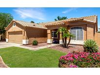 Charming single-story home with a well-maintained lawn and desert landscaping at 10320 W Luke Ave, Glendale, AZ 85307