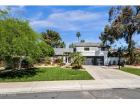 Beautiful home featuring a well-manicured lawn, a basketball hoop, and a modern two-story design at 10360 N 98Th St, Scottsdale, AZ 85258