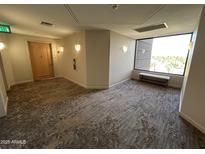 Hallway with seating and large window offering nice natural light at 1040 E Osborn Rd # 602, Phoenix, AZ 85014