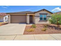 Charming single-story home with a well-manicured front yard and a two-car garage at 1122 E Meadowbrook Dr, Casa Grande, AZ 85122