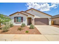 Charming single-story home featuring a two-car garage, neutral stucco, and low-maintenance landscaping at 1142 E Atwood Dr, Casa Grande, AZ 85122