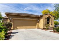 Exterior shot showcasing the two-car garage, neutral colors, and manicured landscaping against a blue sky at 1202 E Binner Dr, Chandler, AZ 85225