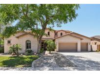 Charming two-story home with a three car garage, lush landscaping, and mature shade tree at 1360 S Camellia Ct, Chandler, AZ 85286