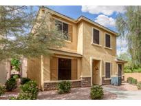 Charming two-story home showcasing a stucco exterior, stone accents, and desert landscaping in a welcoming neighborhood at 14907 N 177Th Ave, Surprise, AZ 85388