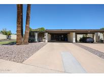 Charming home exterior featuring mature landscaping and a spacious covered carport for convenient parking at 1982 E Oxford Dr, Tempe, AZ 85283