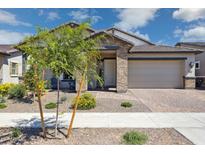 Beautiful single-story home featuring a brick exterior, paver driveway, and a two-car garage at 20606 E Avenida Del Valle Ct, Queen Creek, AZ 85142
