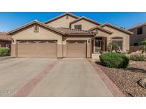 Charming single-story home features a tile roof and a spacious three-car garage at 26249 N 68Th Ln, Peoria, AZ 85383
