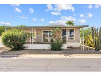 Cozy single-story home with a covered porch, desert landscaping, and a pleasant curb appeal at 2650 W Union Hills Dr # 100, Phoenix, AZ 85027