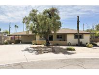 Charming single-story home with a well-manicured yard, mature shade tree, and a desert cactus at 2749 S Rita Ln, Tempe, AZ 85282