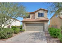 Charming two-story home featuring a large garage, desert landscaping, and a classic tile roof at 31227 N 45Th St, Cave Creek, AZ 85331