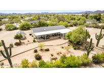 Aerial view of home showcasing covered patio, mature landscaping, and desert setting at 33852 N 52Nd St, Cave Creek, AZ 85331