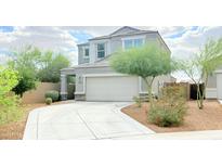 Charming two-story home featuring desert landscaping and a two-car garage at 3402 N 300Th Dr, Buckeye, AZ 85396