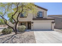Two-story home with a two-car garage, desert landscaping, and a mature shade tree at 3405 W La Salle St, Phoenix, AZ 85041