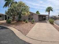 Charming single-story home with well-maintained landscaping and a covered parking area at 5402 E Mckellips Rd # 103, Mesa, AZ 85215