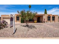 Charming single-story home featuring a brick facade, desert landscaping, and inviting curb appeal at 6622 E Voltaire Ave, Scottsdale, AZ 85254