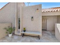 Inviting courtyard entrance featuring textured walls, charming bench, and well-manicured potted plants at 7405 N Via Camello Del Norte -- # 137, Scottsdale, AZ 85258
