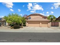 Inviting home featuring a three-car garage, desert landscaping, and a well-maintained exterior at 7438 E Glenn Moore Rd, Scottsdale, AZ 85255