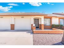 Charming single-story home featuring a well-manicured lawn, two-car garage, and inviting entryway at 8255 E Kiva Ave # 422, Mesa, AZ 85209