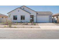 Charming single-story home featuring a two-car garage and professionally landscaped front yard at 852 W Golden Ore Pass, Apache Junction, AZ 85120
