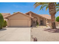 Charming single-story home with a two-car garage, desert landscaping, and tile roof at 9243 W Kimberly Way, Peoria, AZ 85382