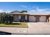 Charming brick home with a well-maintained front yard, covered entry and two-car garage at 9602 W Ironwood Dr # A, Peoria, AZ 85345