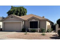 Charming single-story home with a two-car garage and well-maintained desert landscaping at , Mesa, AZ 85205