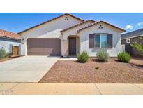 Charming single-story home with a well-maintained front yard, two car garage, and desert landscaping at 1130 E Westwood Dr, Casa Grande, AZ 85122