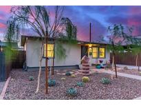 Charming single-story home featuring xeriscaped landscaping with cacti and rock ground cover at 146 E 1St St, Mesa, AZ 85201