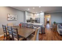Open-concept dining area featuring a wooden table, seating for eight, and views of the modern kitchen at 20100 N 78Th Pl # 3126, Scottsdale, AZ 85255