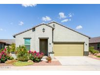 Charming single-story home with a well-maintained front yard and a two-car garage at 21150 N Evergreen Dr, Maricopa, AZ 85138