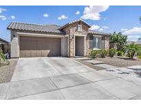 Charming home featuring a stone facade, two-car garage, and a well-manicured front yard at 25421 S 228Th St, Queen Creek, AZ 85142