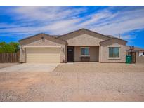Charming single-story home featuring a two-car garage, low-maintenance landscaping, and a welcoming front porch at 34834 N Surrey Ln, San Tan Valley, AZ 85140