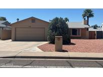 Charming single-story home with a two car garage and desert landscaping on a sunny day at 3779 E Sweetwater Ave, Phoenix, AZ 85032